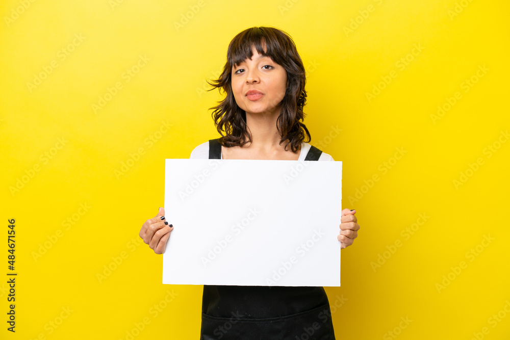 Restaurant waiter latin woman isolated on yellow bakcground holding an empty placard with happy expression Restaurant waiter latin woman isolated on yellow bakcground holding an empty placard with happy expression
