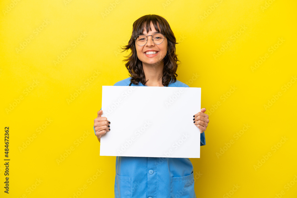 Young nurse doctor woman isolated on yellow background holding an empty placard with happy expression Young nurse doctor woman isolated on yellow background holding an empty placard with happy expression