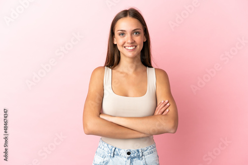 Young woman over isolated pink background keeping the arms crossed in frontal position © luismolinero