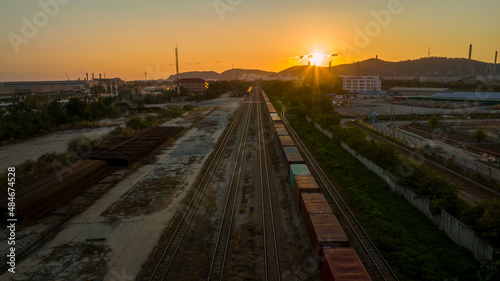Train station at sunset , Cargo container train in evening import export custom transportation concept.