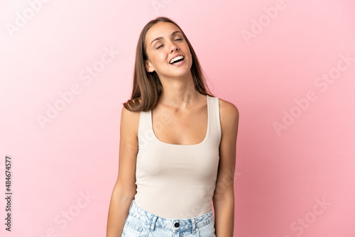 Young woman over isolated pink background laughing