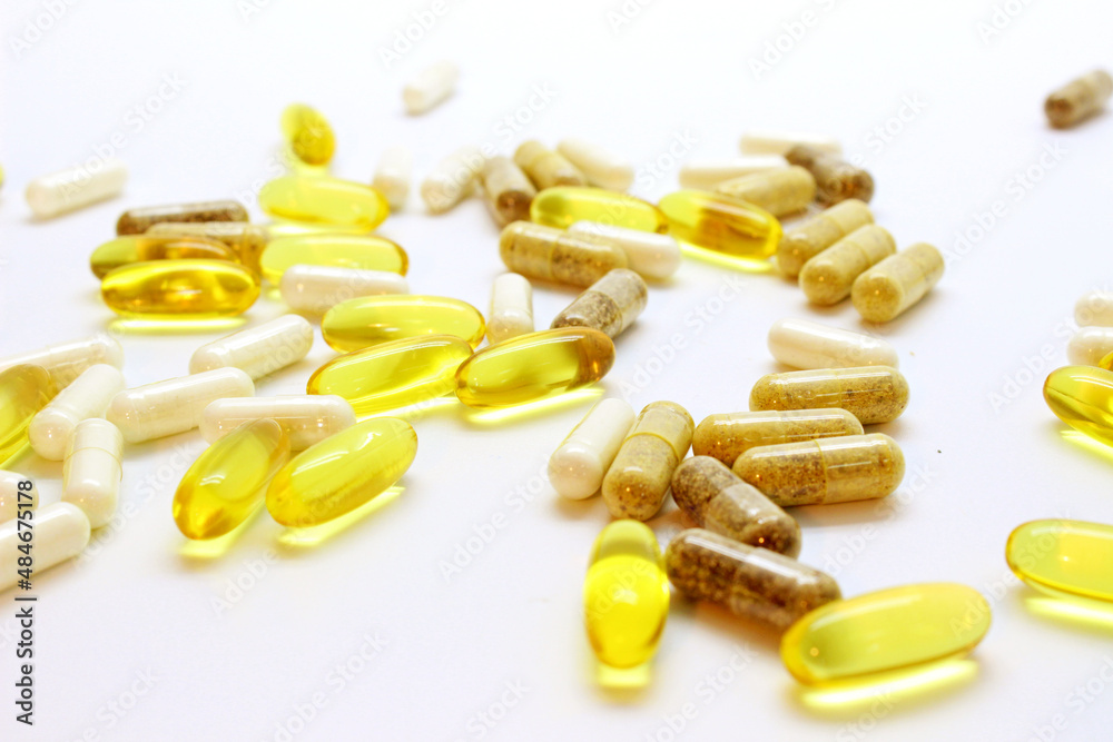 fish oil capsules and tablets scattered on the table on a light background macro, dietary supplements, omega 3, fish fat fish oil capsules and tablets scattered on the table on a light background macro, dietary supplements, omega 3, fish fat