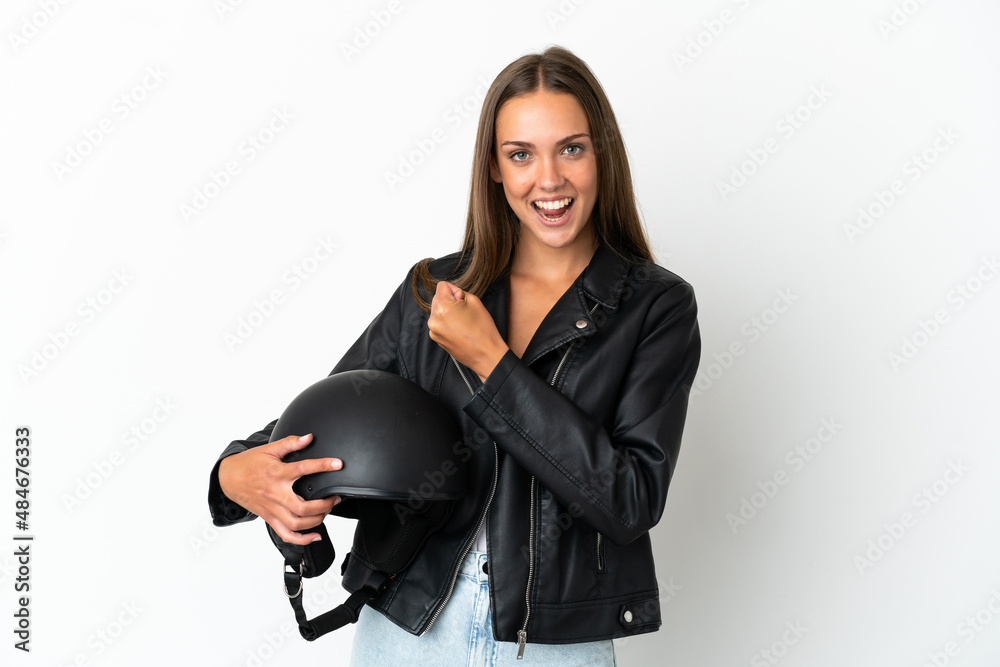 Woman with a motorcycle helmet over isolated white background celebrating a victory Woman with a motorcycle helmet over isolated white background celebrating a victory