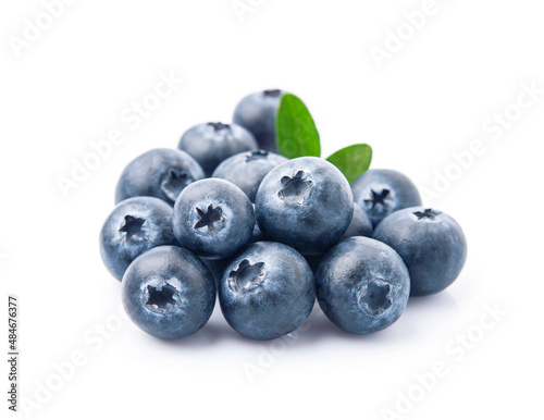 Ripe blueberries with leaves on white backgrounds.