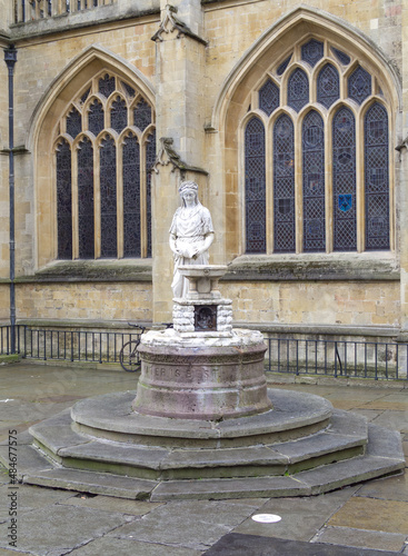 Bath Abbey England UK Stained glass windows and bath stone detailing with water fountain statue