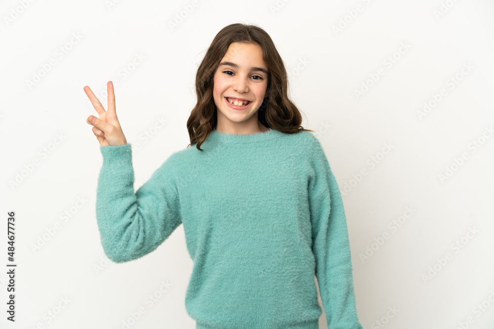 Little caucasian girl isolated on white background smiling and showing victory sign Little caucasian girl isolated on white background smiling and showing victory sign