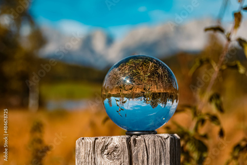 Crystal ball alpine landscape shot with the famous Wilder Kaiser mountains in the background at the Schwarzsee lake, Tyrol, Austria © Martin Erdniss