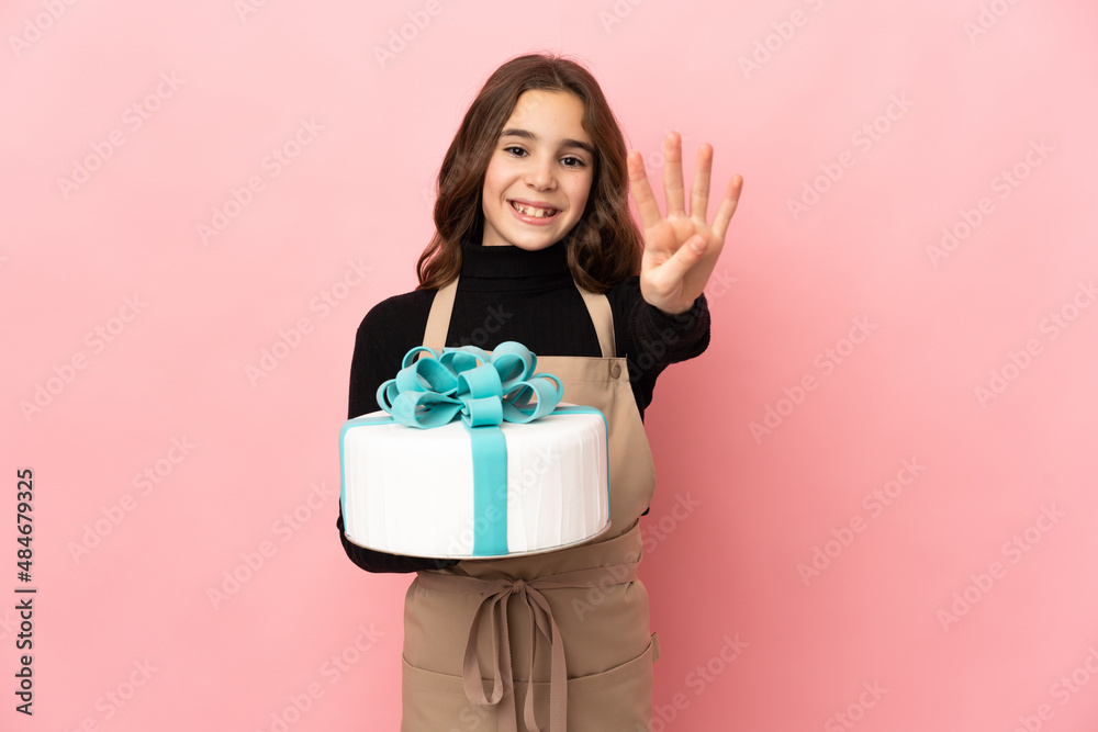 Little Pastry chef holding a big cake isolated on pink background happy and counting four with fingers Little Pastry chef holding a big cake isolated on pink background happy and counting four with fingers