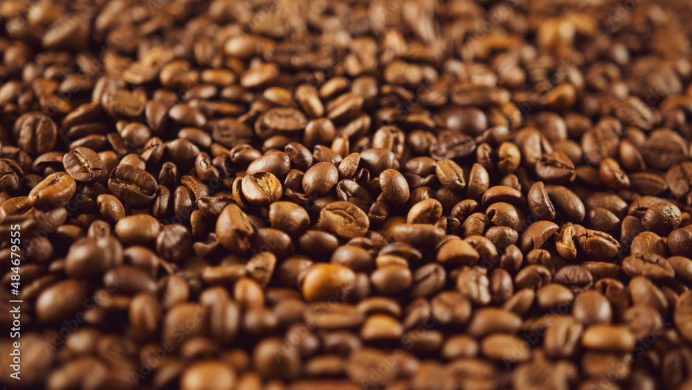 Fototapeta premium Texture of freshly coffee beans. Lots of roasted beans for preparation of fragrant drink. Close up.