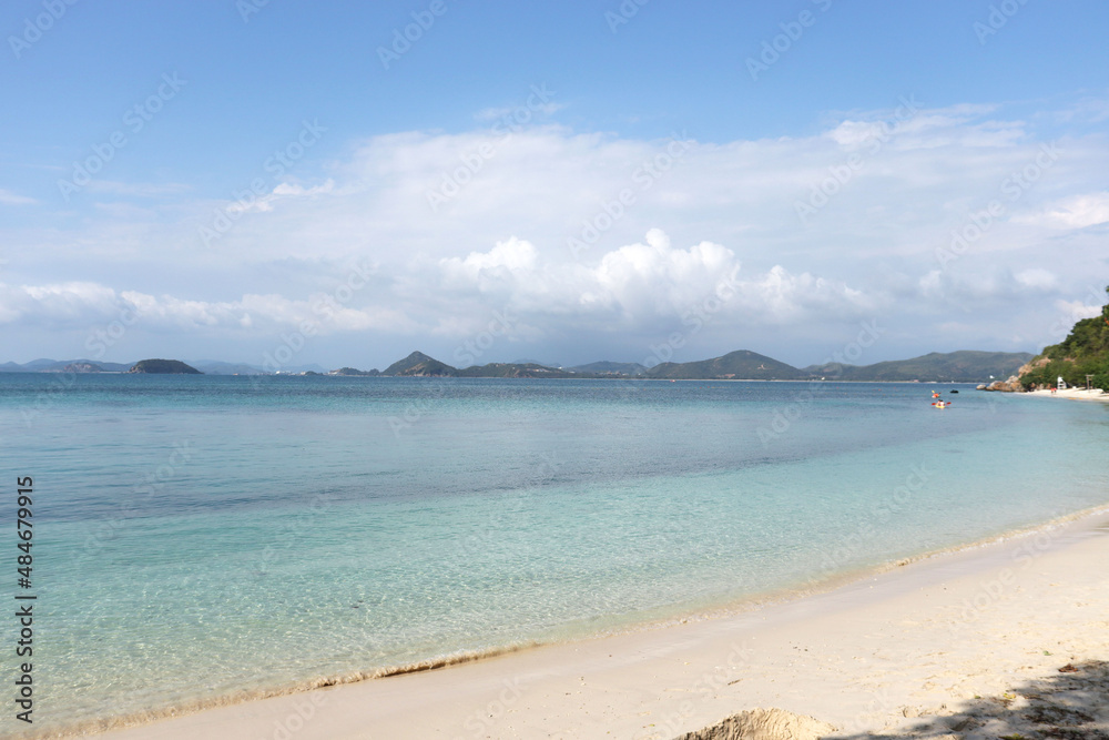 Landscape with white beach, the sea, the beautiful clouds in the blue sky and crystal clear water.