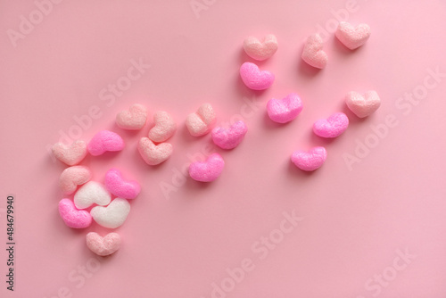 Valentine's Day concept with red hearts on pink background © cenchild