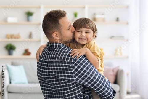 Free Download Parental love concept. Loving father kissing his little son, adorable boy enjoying daddy's tenderness at home - GFXLoad