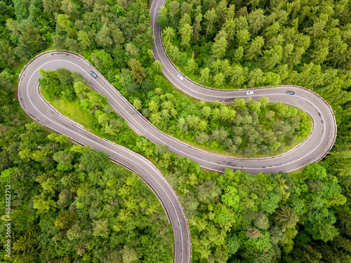 Winding road trough dense forest. Aerial drone view, top down © Rafaila Gheorghita