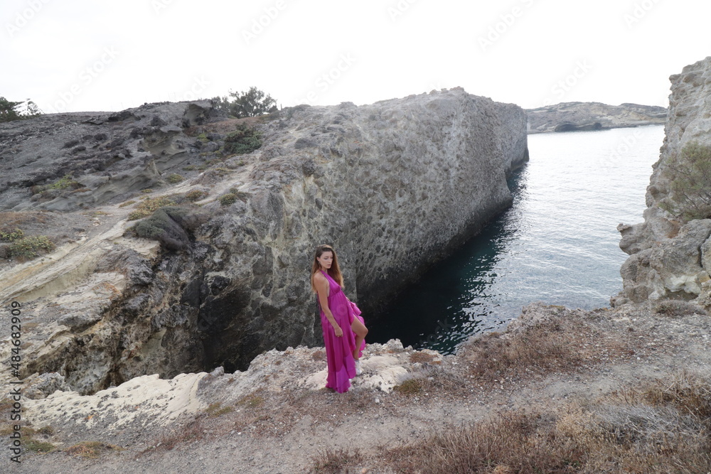 woman in a pink dress on a beach in milos greece