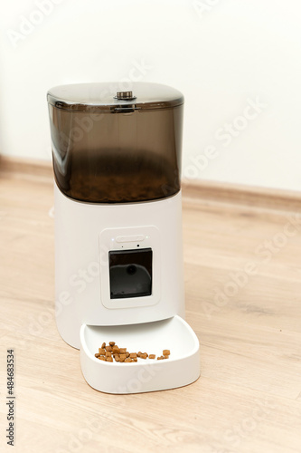 smart pet feeder. feeder with remote control and built-in camera. cat food station bowl of food.