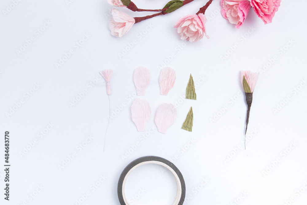 Create a sakura flower from 4 light pink crepe paper petals. Cut out the petals and fasten with a thread on a wire with a stamen