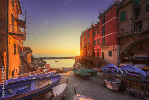 Riomaggiore village street, boats and sea at sunset. Cinque Terre, Ligury, Italy.