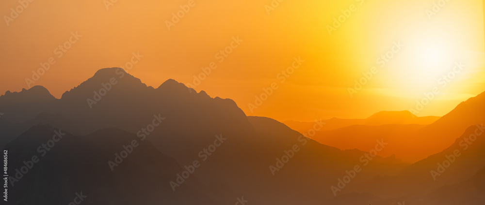 orange panorama - misty mountains at sunset