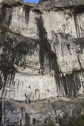 Rock climbing on a shear limestone rock face. photo
