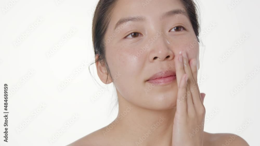 Close Up Shot of Young Woman Blending Moisturiser Close Up Shot of Young Woman Blending Moisturiser