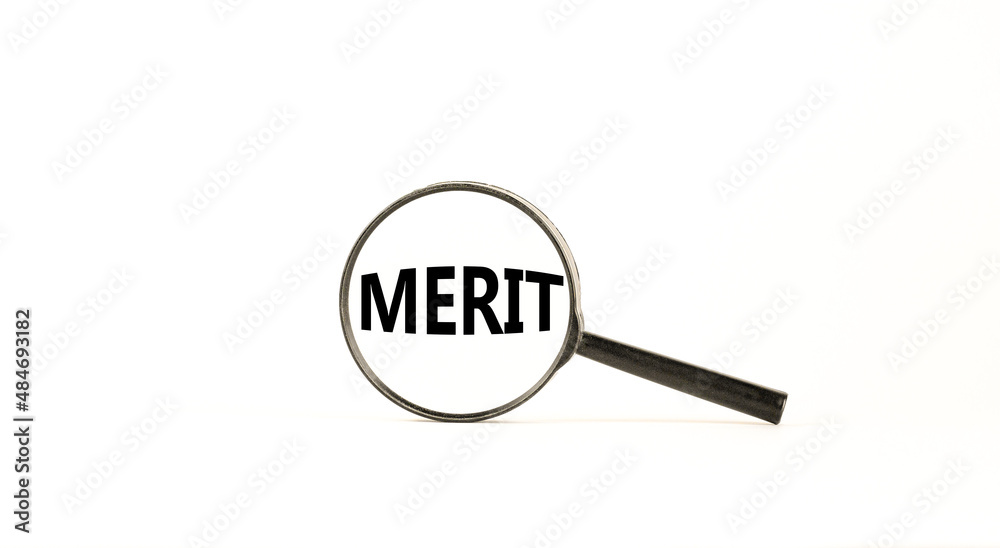 Merit symbol. Magnifying glass with word merit on a beautiful white table, white background. Businessman hand. Business and merit concept, copy space. Merit symbol. Magnifying glass with word merit on a beautiful white table, white background. Businessman hand. Business and merit concept, copy space.