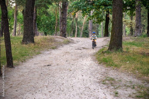 Cyclist Riding down the sandy Hill on the Offroad Trail © pahis