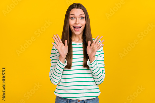 Photo of excited pretty lady dressed striped shirt smiling rising arms isolated yellow color background