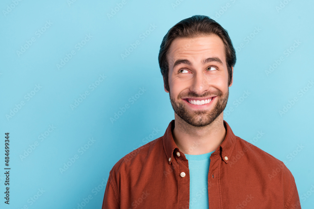 Portrait of young attractive male look copyspace dreaming see advert promotion isolated on blue color background Portrait of young attractive male look copyspace dreaming see advert promotion isolated on blue color background