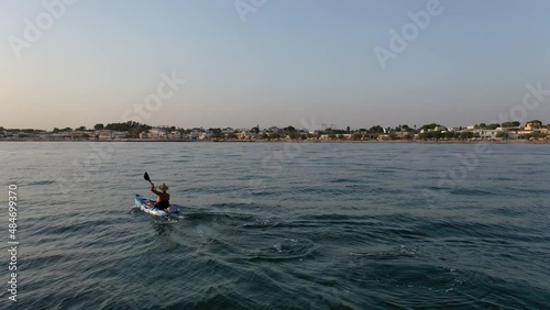 Man paddling a kayak in the sea