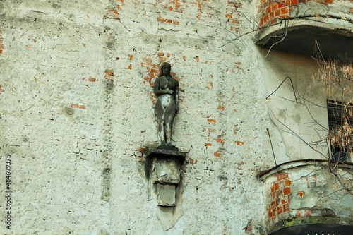  Sculpture of a woman on a dilapidated facade of an old residential building 