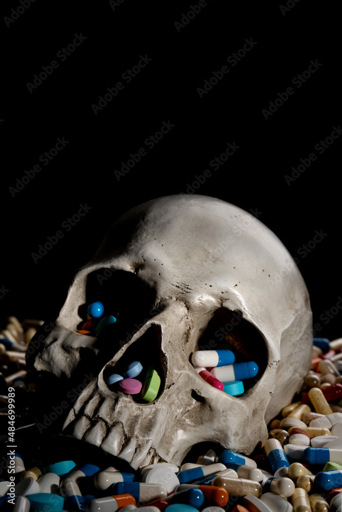 Human Skull and Pills. Danger and problem of being addicted to and overdose of prescribed medicine... Human Skull and Pills. Danger and problem of being addicted to and overdose of prescribed medicine...