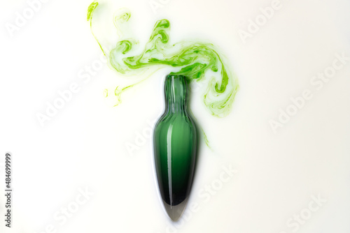 Bilde på lerret Potion in green glass flask bottle on white background