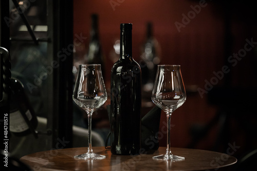 wine glasses and bottles of wine in the entourage of the wine bar in the evening