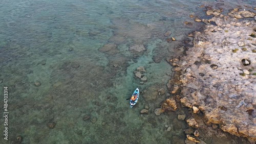 Man paddling a kayak in the sea