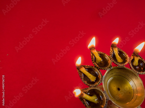 hindu puja essential panch pradeep or five headed oil lamp burning with glowing flame. these are used in durga , saraswati , kali , laxmi puja, shivaratri. photo
