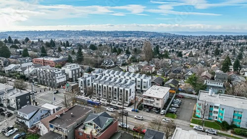 Aerial view of a Seattle area neighborhood, circling to approach a row of newly constructed townhomes photo