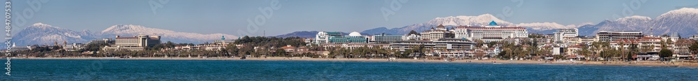 panorama of the Antalya coast with a huge number of five-star hotels, palm trees, promenade, sandy beach in Side Turkey