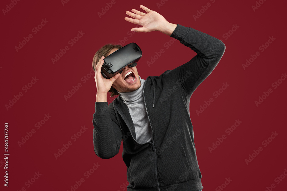 Scared man playing game in virtual reality Scared man playing game in virtual reality
