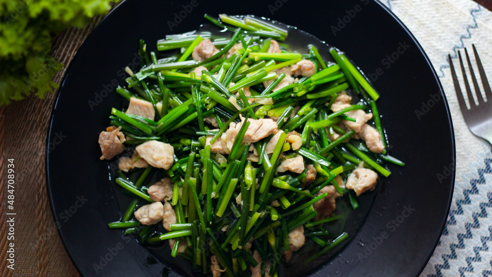 Stir-fried morning glory in a black dish Stir-fried morning glory in a black dish