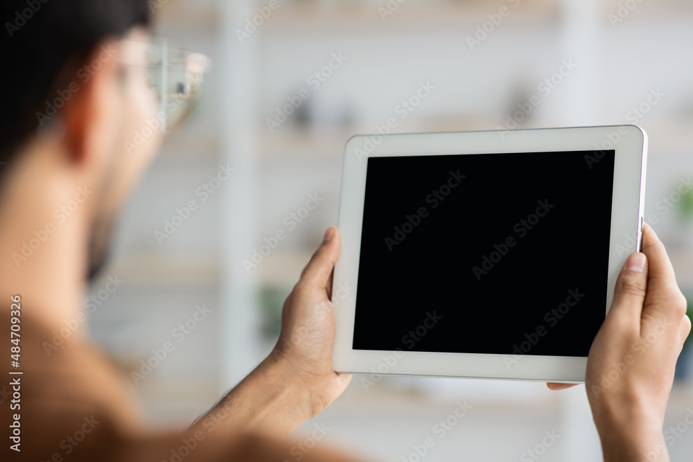 Unrecognizable young man holding digital tablet, mockup Unrecognizable young man holding digital tablet, mockup