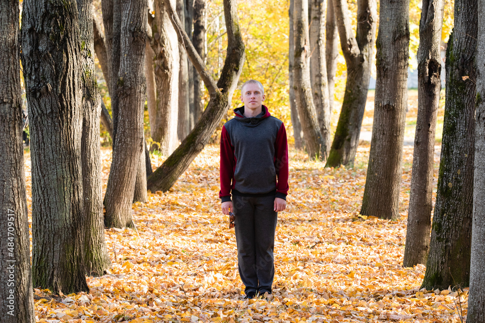 Sporty man walking in autumn park Sporty man walking in autumn park