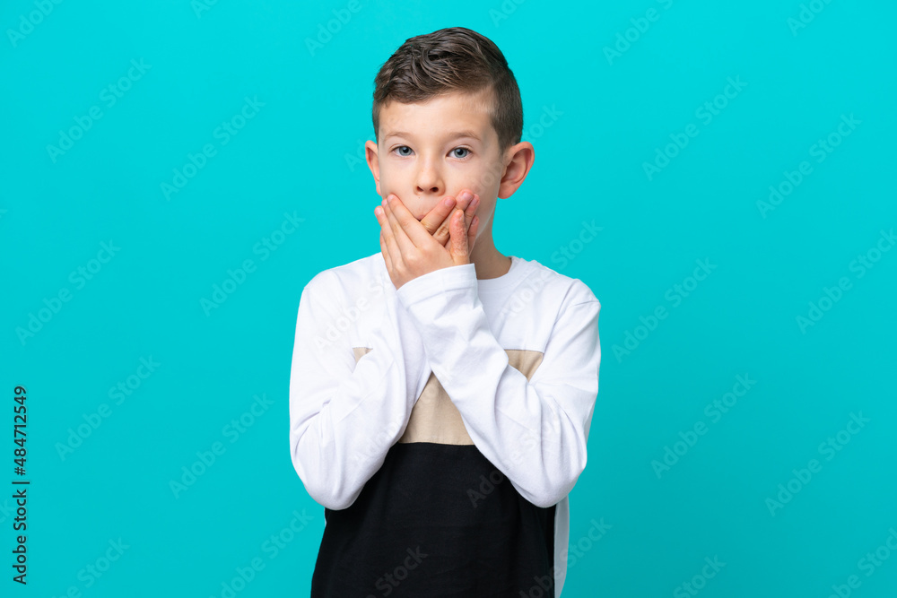 Little kid boy isolated on blue background covering mouth with hands Little kid boy isolated on blue background covering mouth with hands