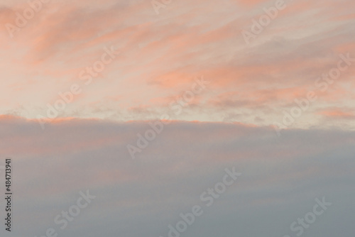 At sunset, blue sky with pink clouds. There is space for text