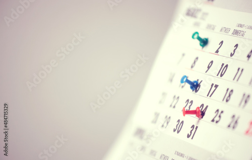 Close-up of a calendar page, with dates marked.