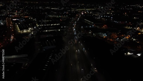 Low dark aerial view of UK motorway traffic through an industrial area photo