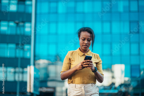 African american woman using a smartphone while out in the city