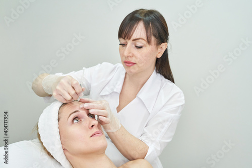Injection at spa salon. Doctor hands in gloves. Closeup. Pretty female patient. Beauty treatment. Healthy skin procedure. Young women face. Plasmolifting rejuvenation