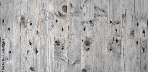 old wood texture ,Wooden panel made of old boards, nailed,  light gray colors.  Fence painted with white paint.Boards of pine with knots, cracks, nailed, jointing boards on the length and 