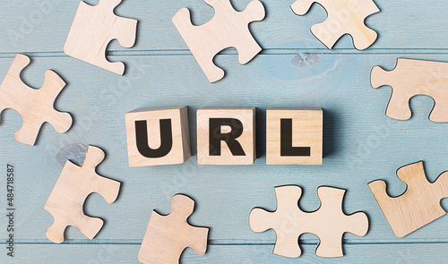Blank puzzles and wooden cubes with the text URL Uniform Resource Locator lie on a light blue background.