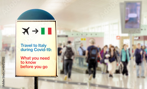 a signal inside an airport that warns about what to know before flying to Italy during the Covid-19 pandemic